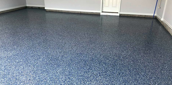 This image shows a garage with a flake epoxy floor.