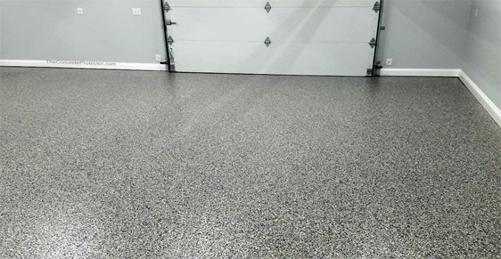 This image shows a garage with a flake epoxy floor.