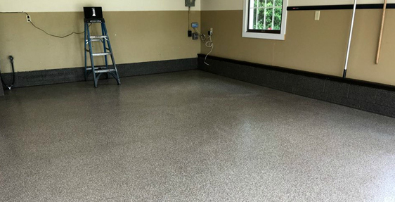 This image shows a garage with a flake epoxy floor.