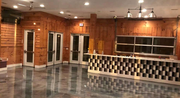 This image shows a commercial space with a gray metallic epoxy floor.