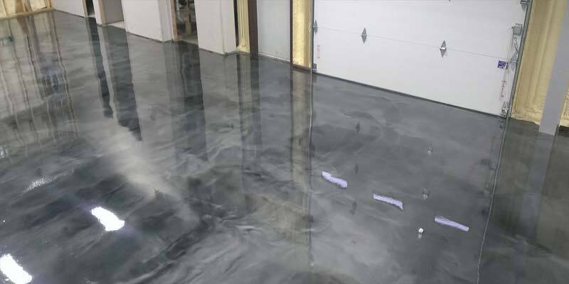 Metallic Epoxy Flooring This image shows a commercial space with a metallic epoxy floor.